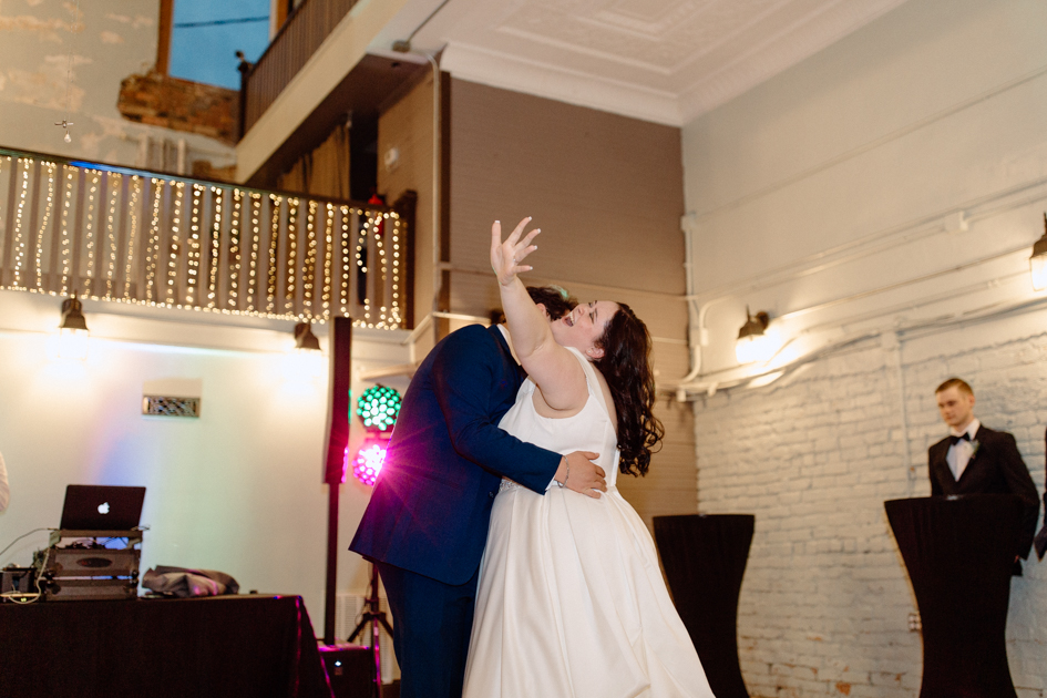 a bride and groom dancing during wedding reception at wilburn lofts in downtown fayetteville
