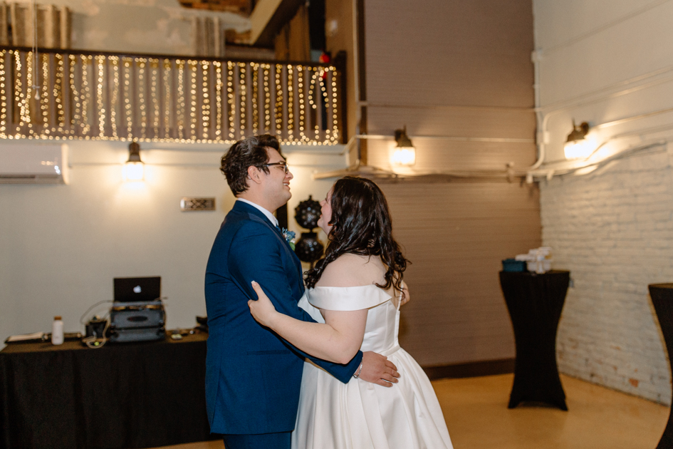 a bride and groom's having their last dance during their wedding at wilburn lofts in downtown fayetteville
