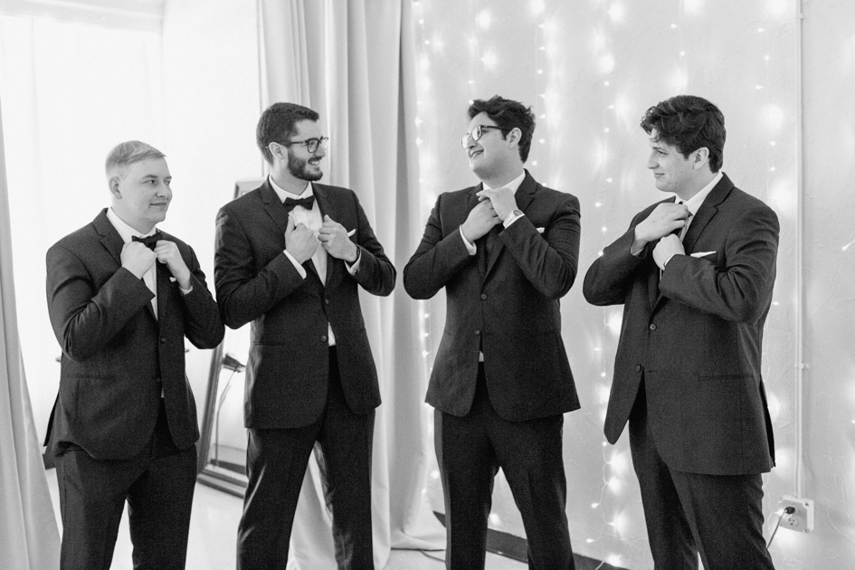 groom and groomsmen getting ready for downtown fayetteville wedding