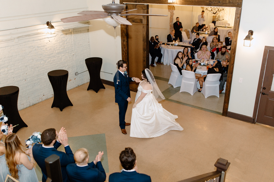 a bride and groom's first dance during their wedding reception at wilburn lofts in downtown fayetteville