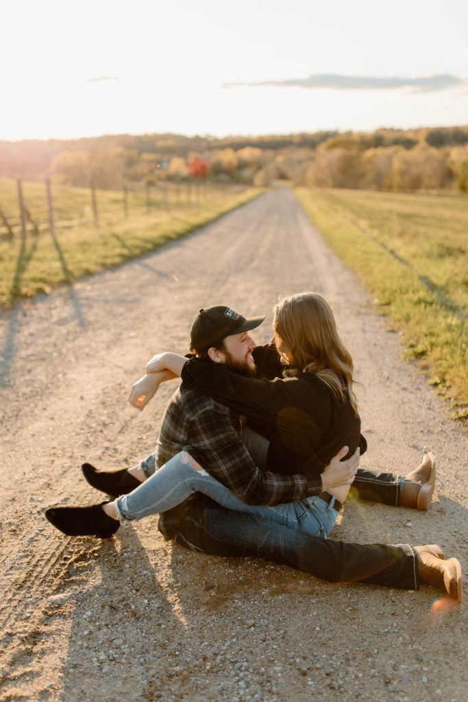 couple posing on a dirt road