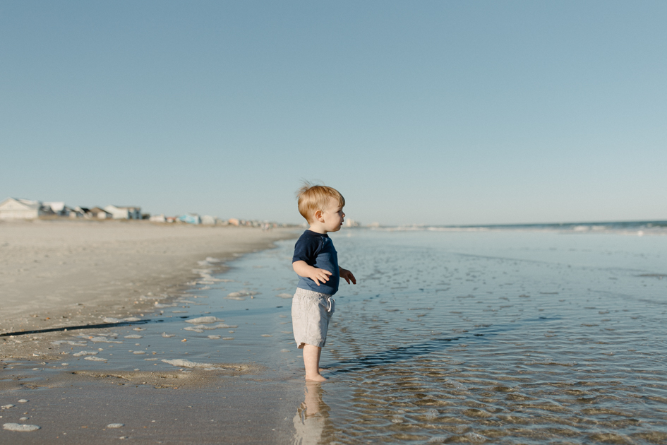 a young boy enjoying myrtle beach during family photos