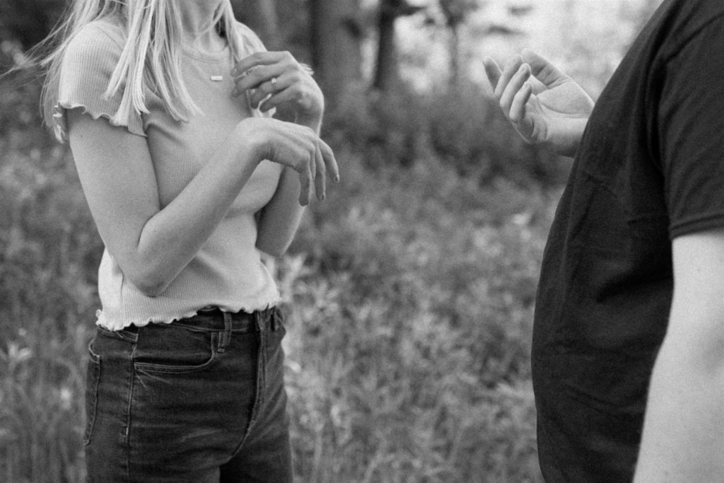 deaf asl couple signing to one another during engagement photos in minneapolis